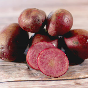 Late-season Terra Rosa fingerling potato seed from SeedsNow-Potatoes, showing small, elongated reddish-brown potatoes with smooth skin.